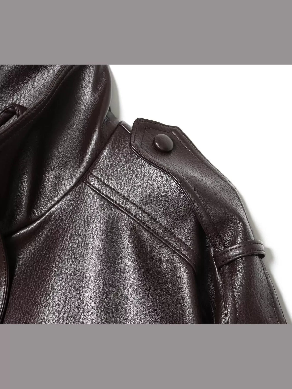 Dark brown faux leather cropped bomber jacket — design and construction details