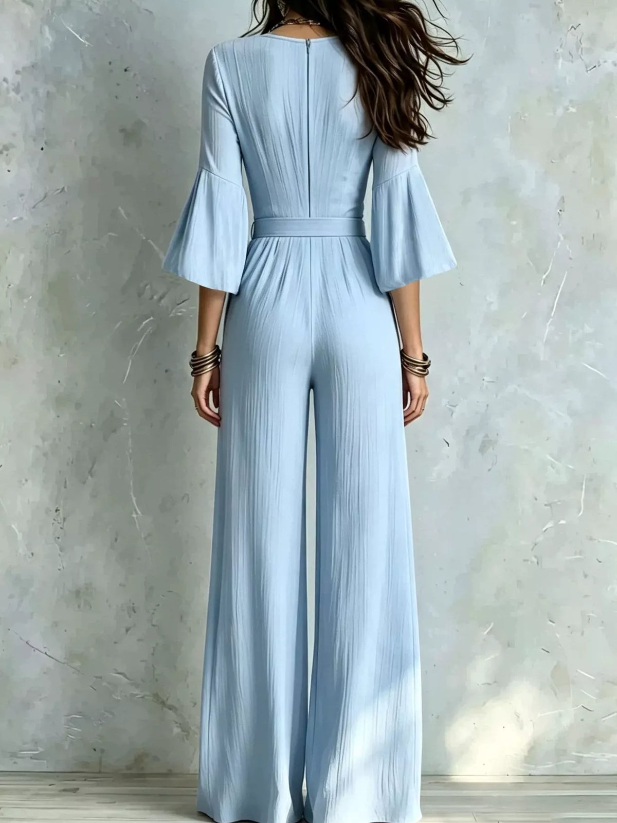 Light blue pleated wide-leg jumpsuit with tie-waist, back view