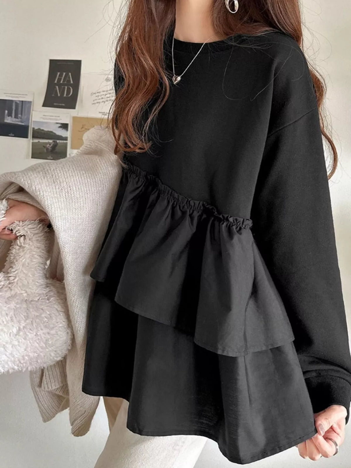 Black color-block ruffled hem top, back view