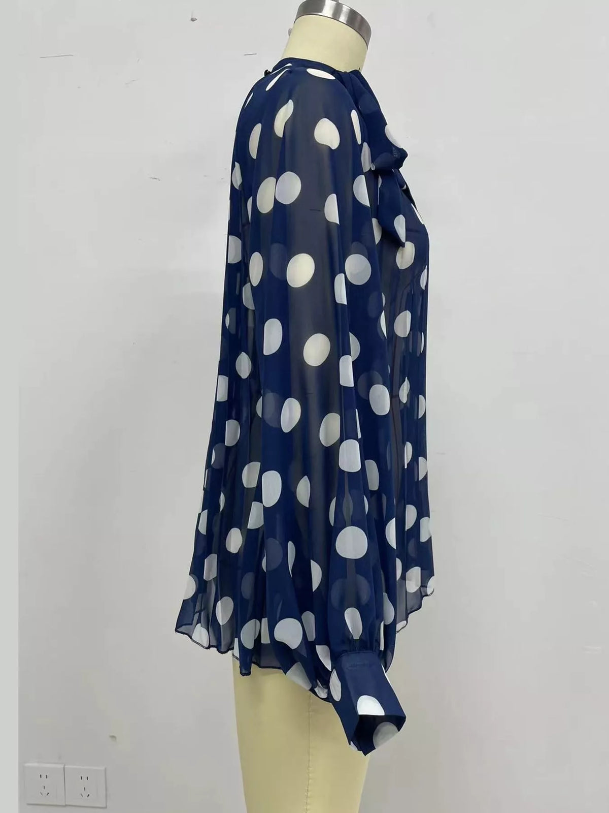 Navy polka dot long sleeve blouse, detail view