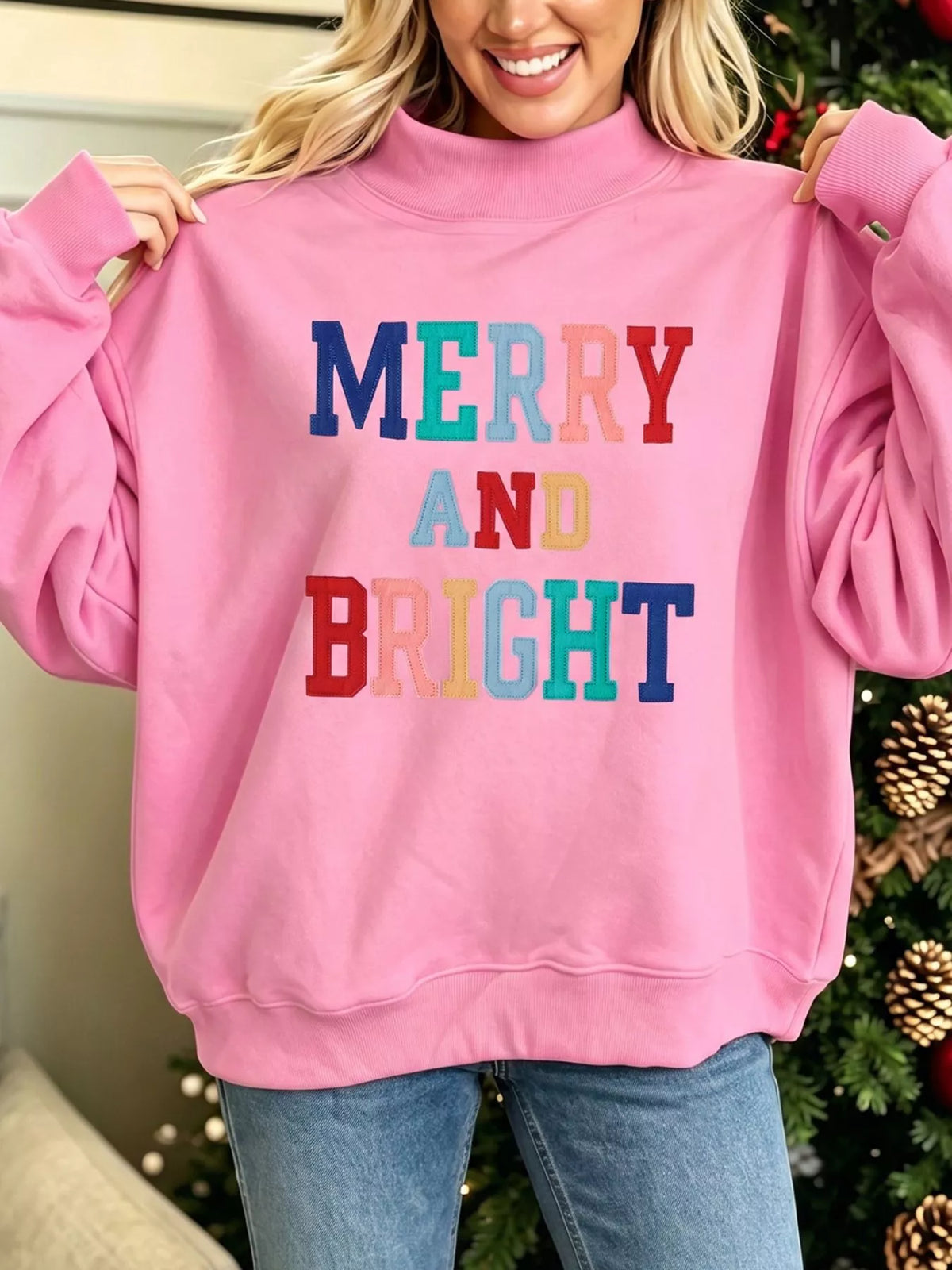 MERRY AND BRIGHT sweatshirt, pink front held out