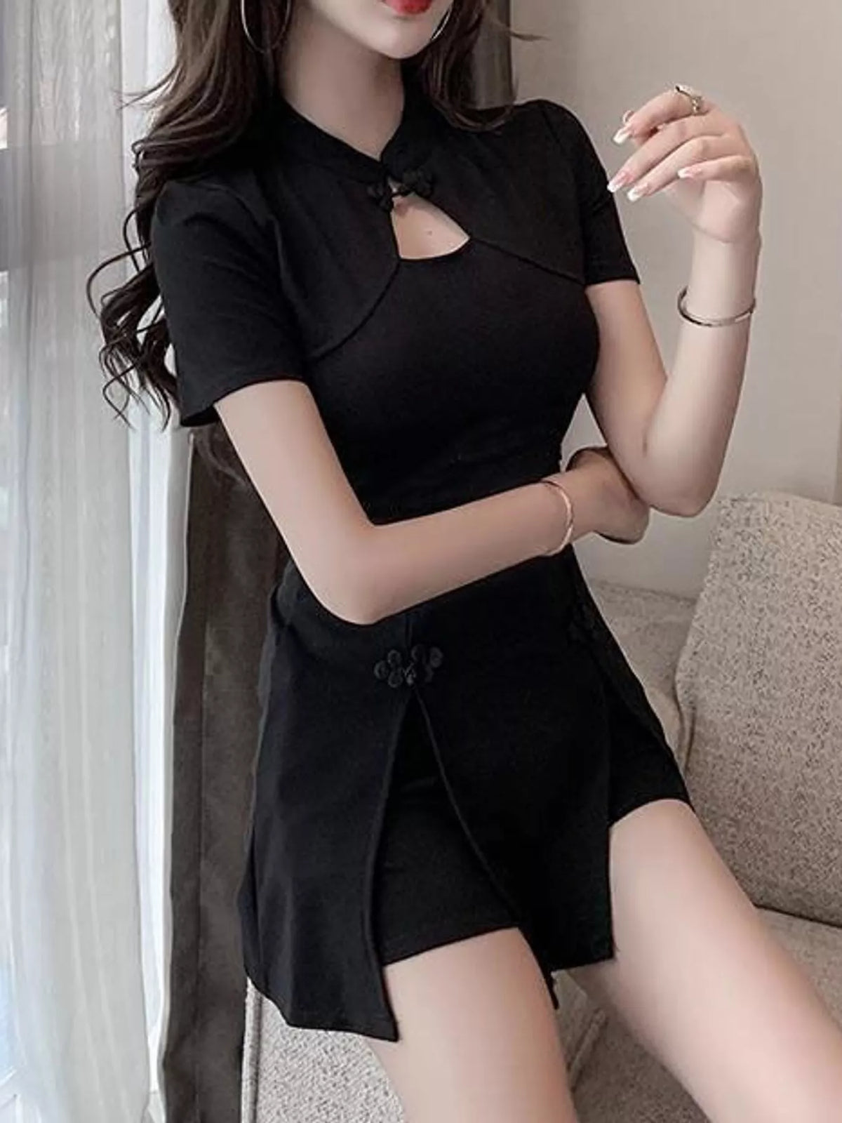 Black romper dress showing the neckline cutout and skirt opening