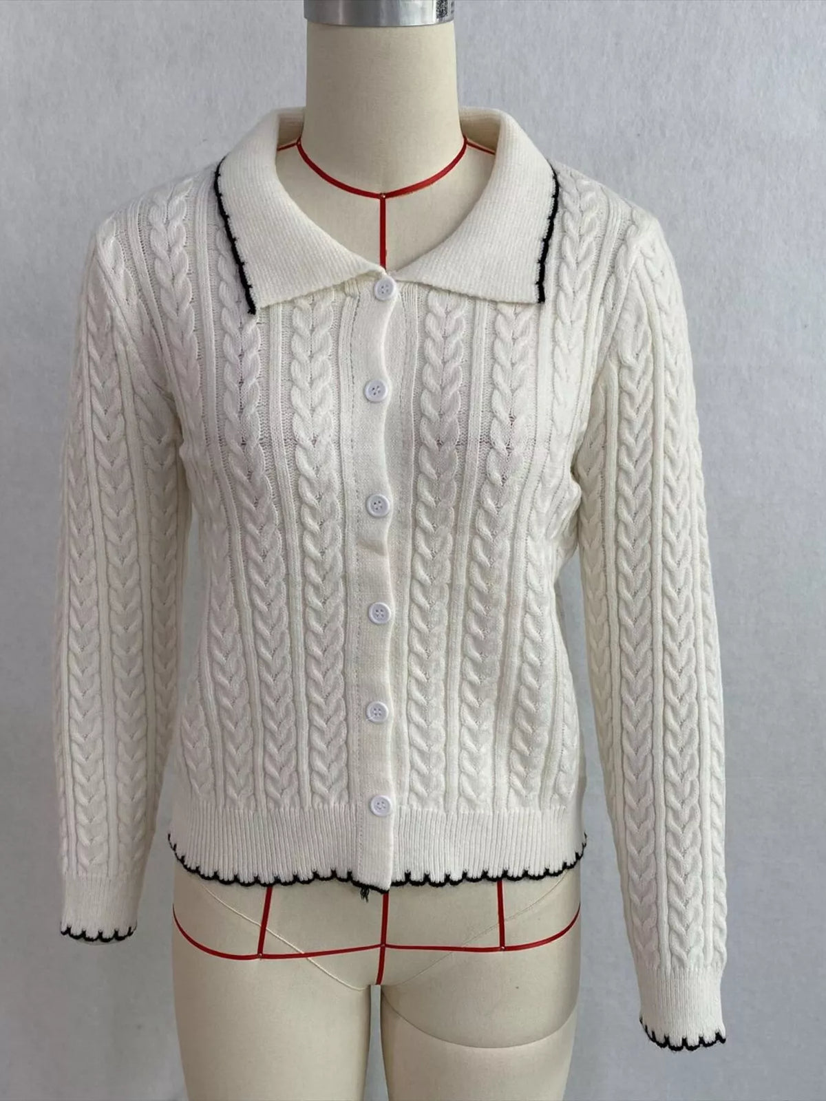 Ivory cable-knit polo-collar cardigan, front on dress form.