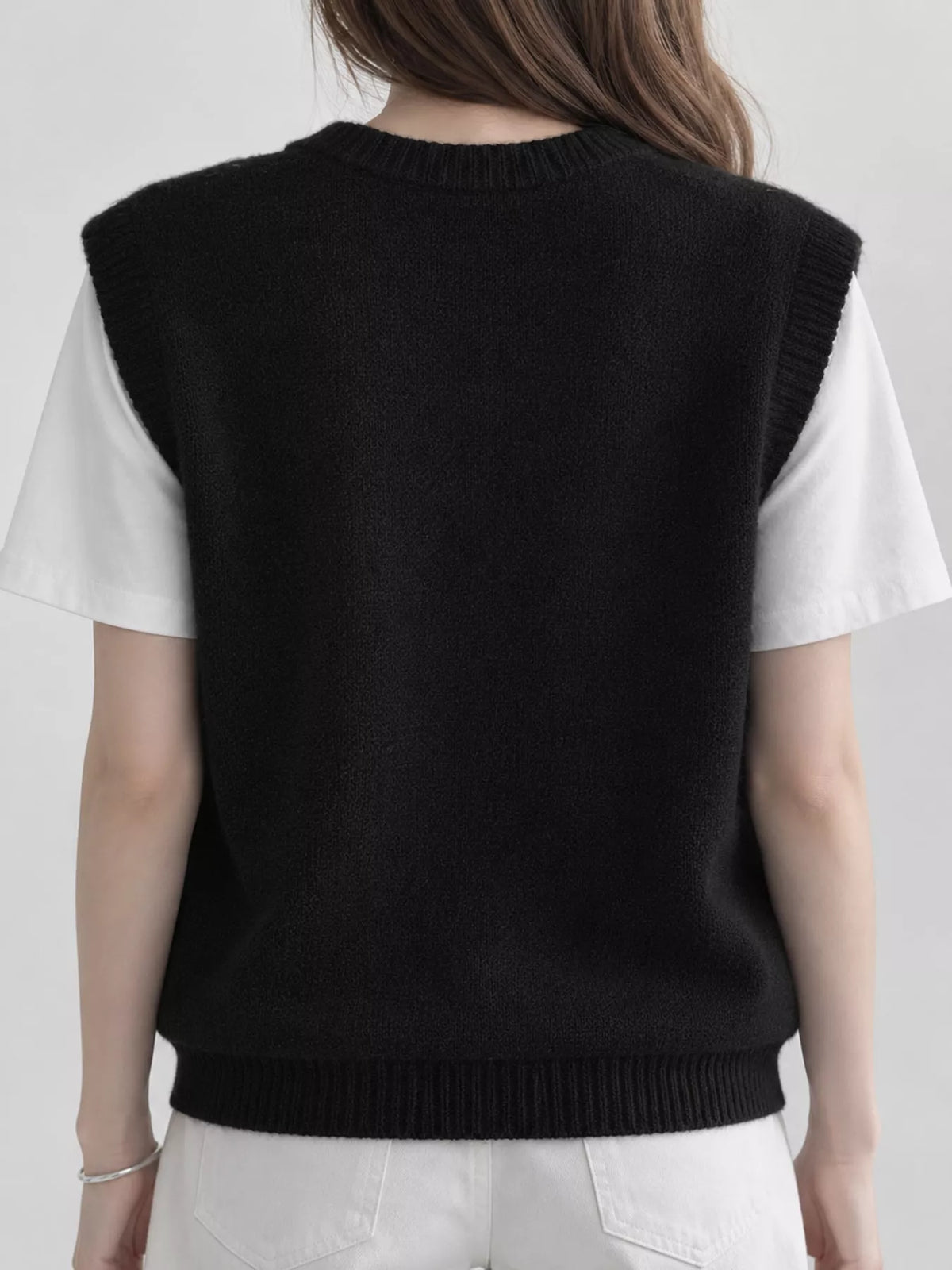 Black v-neck knit sweater vest, back view