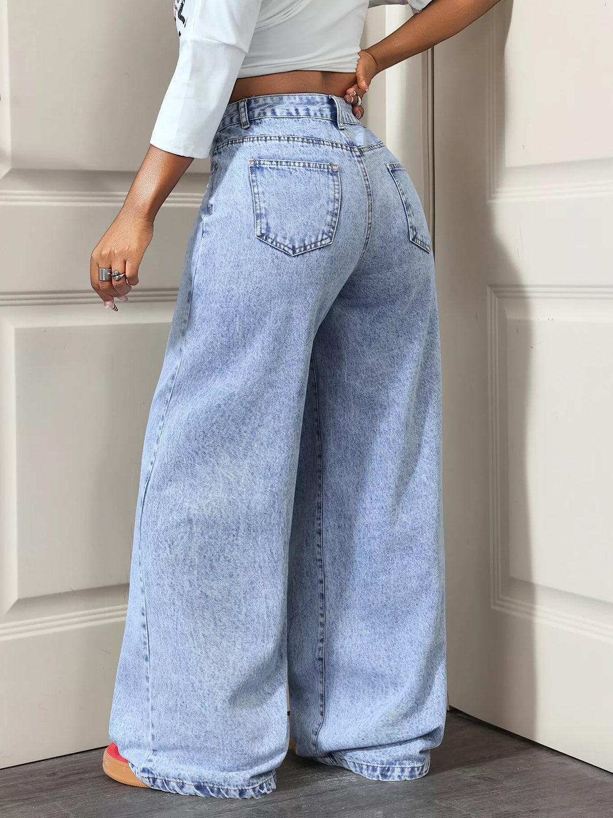 Light blue asymmetric-wrap wide-leg jeans, back view