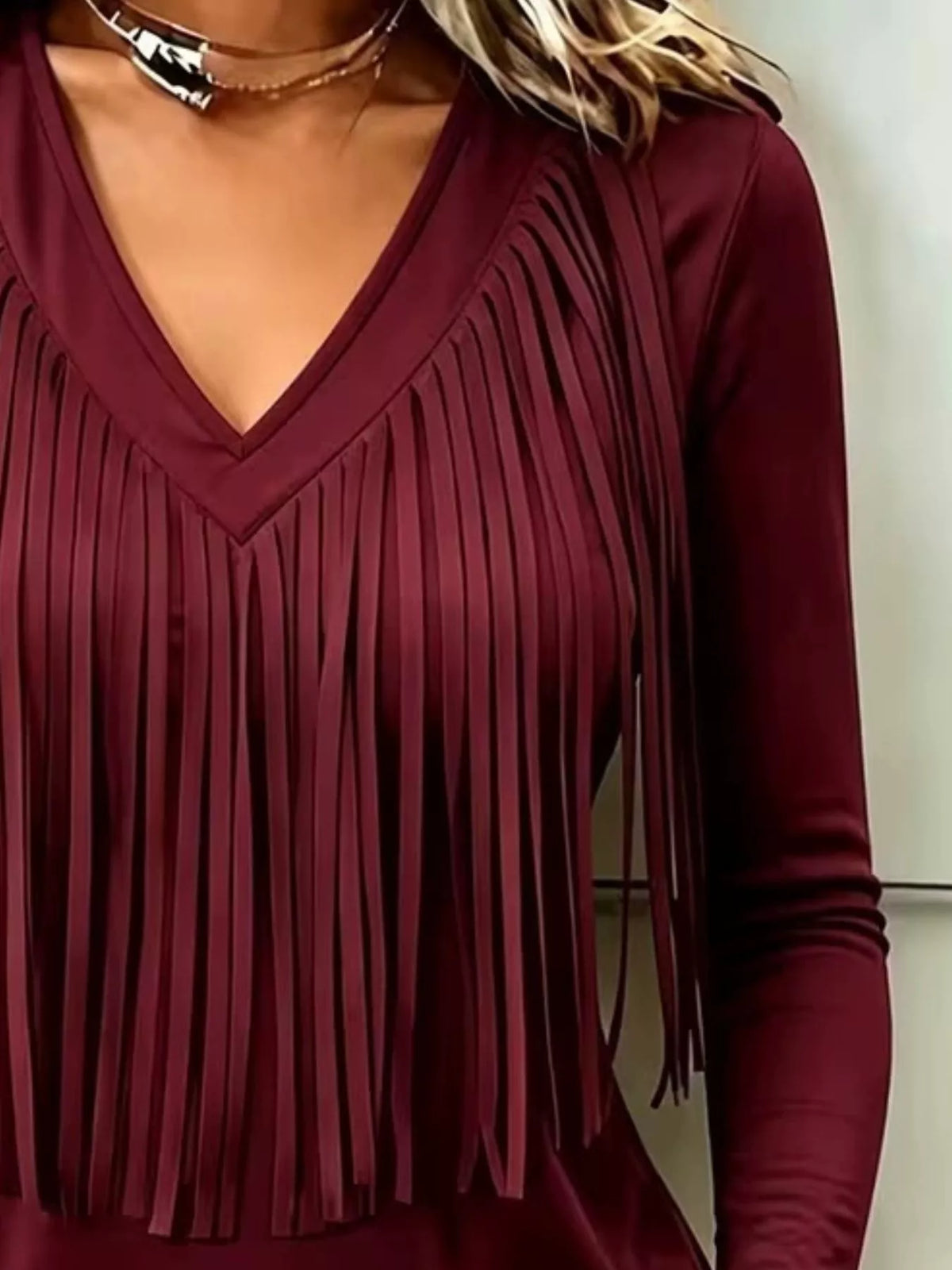Burgundy fringe V-neck top, neckline and fringe close-up