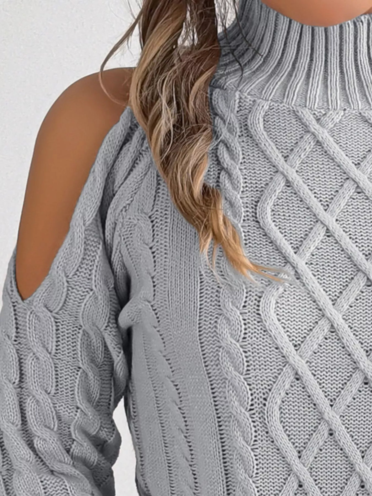 Gray cold-shoulder cable-knit sweater, shoulder cutout and cable knit detail.