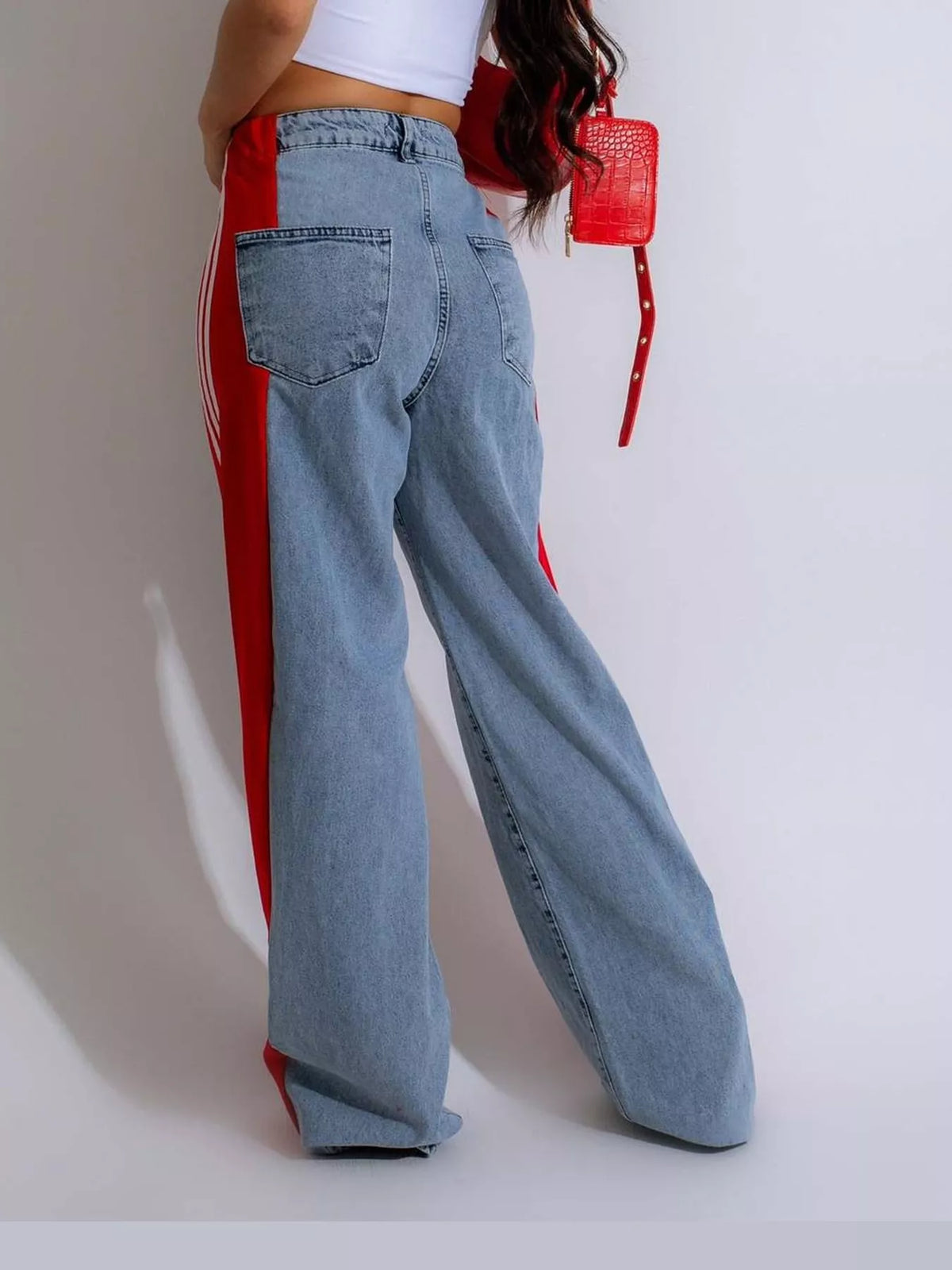 Red high-waisted wide-leg jeans with side stripe detail, back view