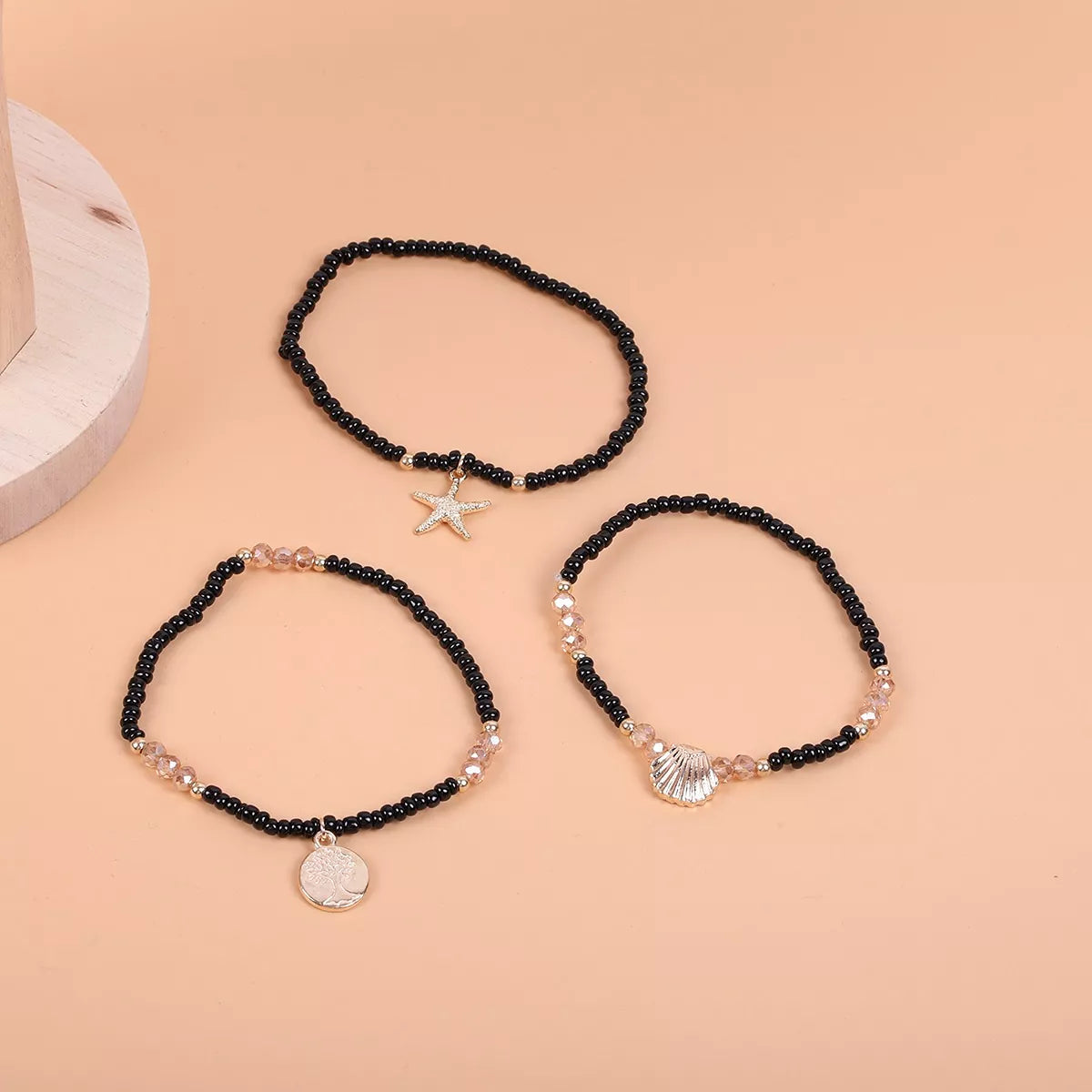 Black and gold-tone three-piece beaded anklet set