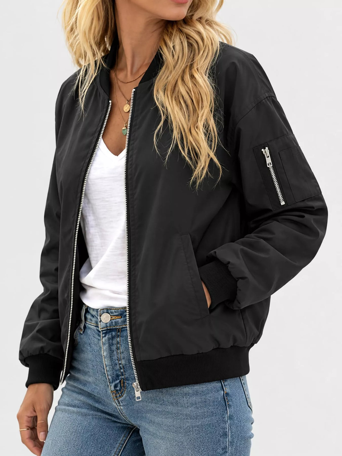 Black zip-up bomber jacket — side view