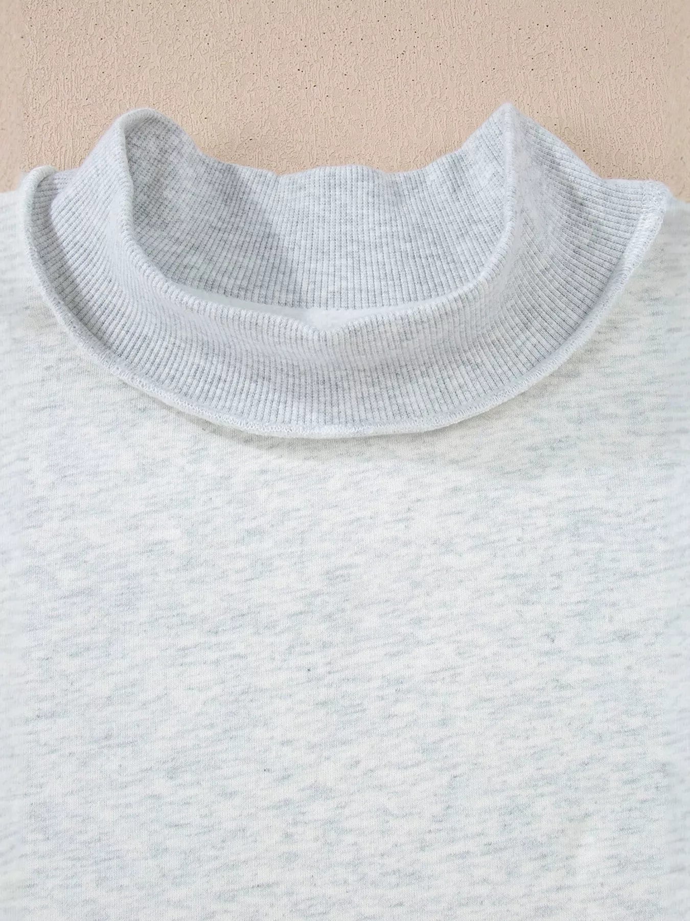 Mock-neck exposed-seam long sleeve sweatshirt