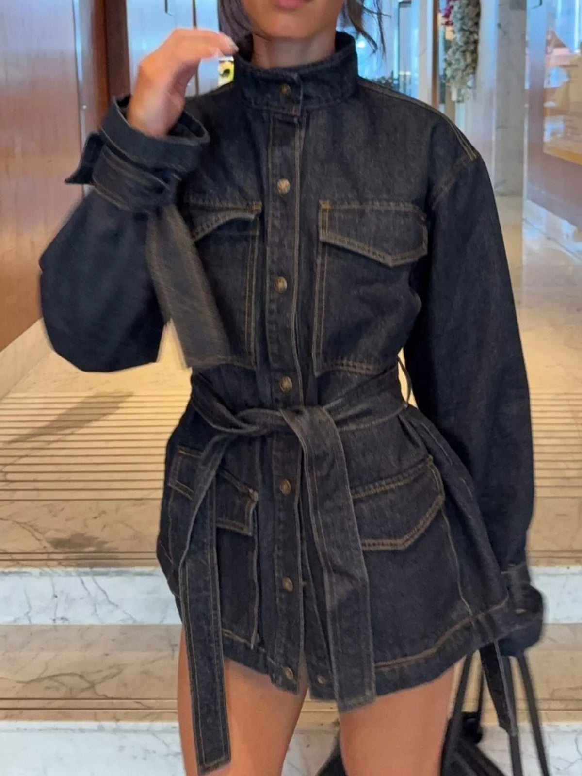 Dark blue button-up belted denim jacket — front view