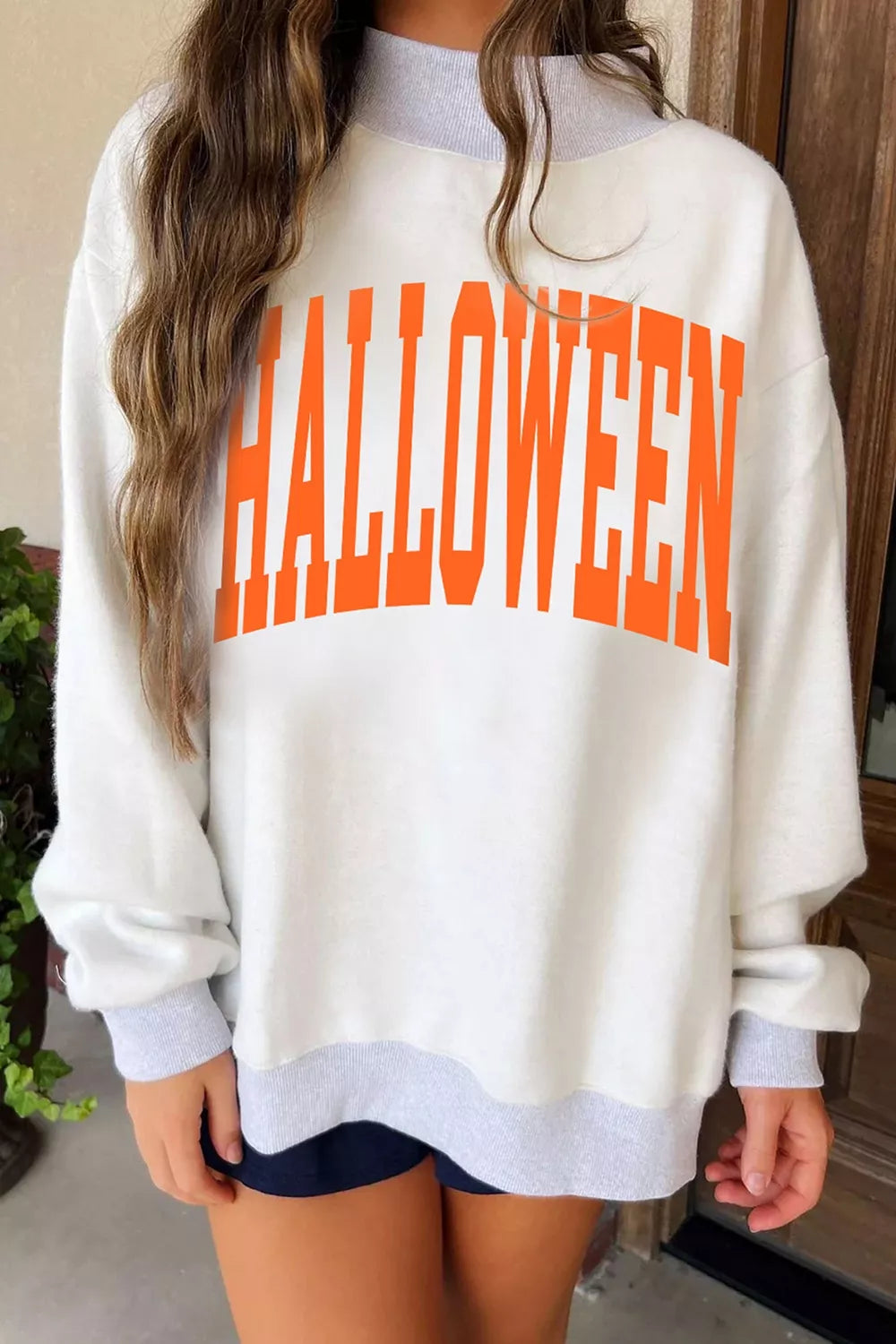 Women's pumpkin face print mock-neck reversible Halloween sweatshirt