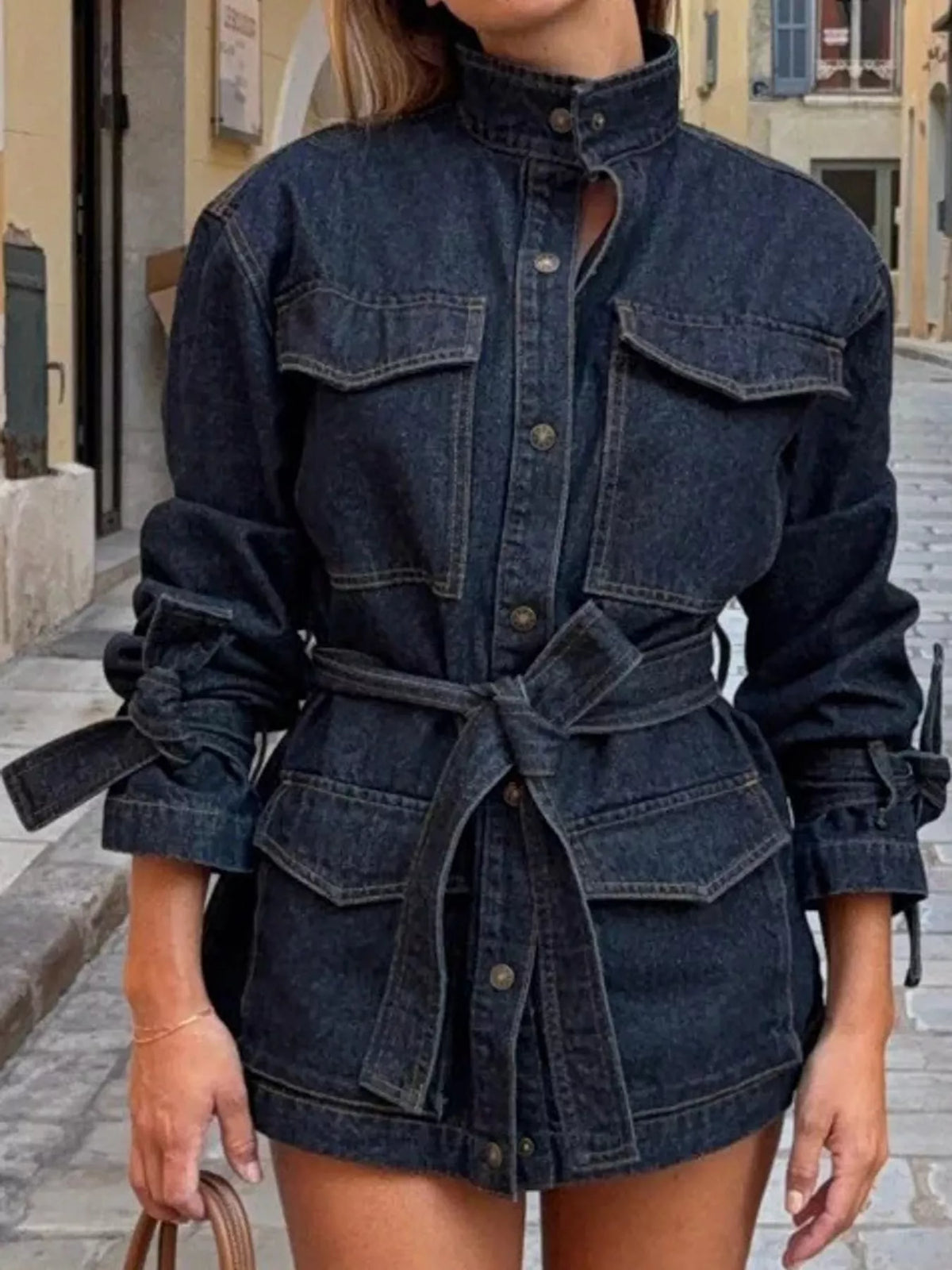Dark blue button-up belted denim jacket — front view