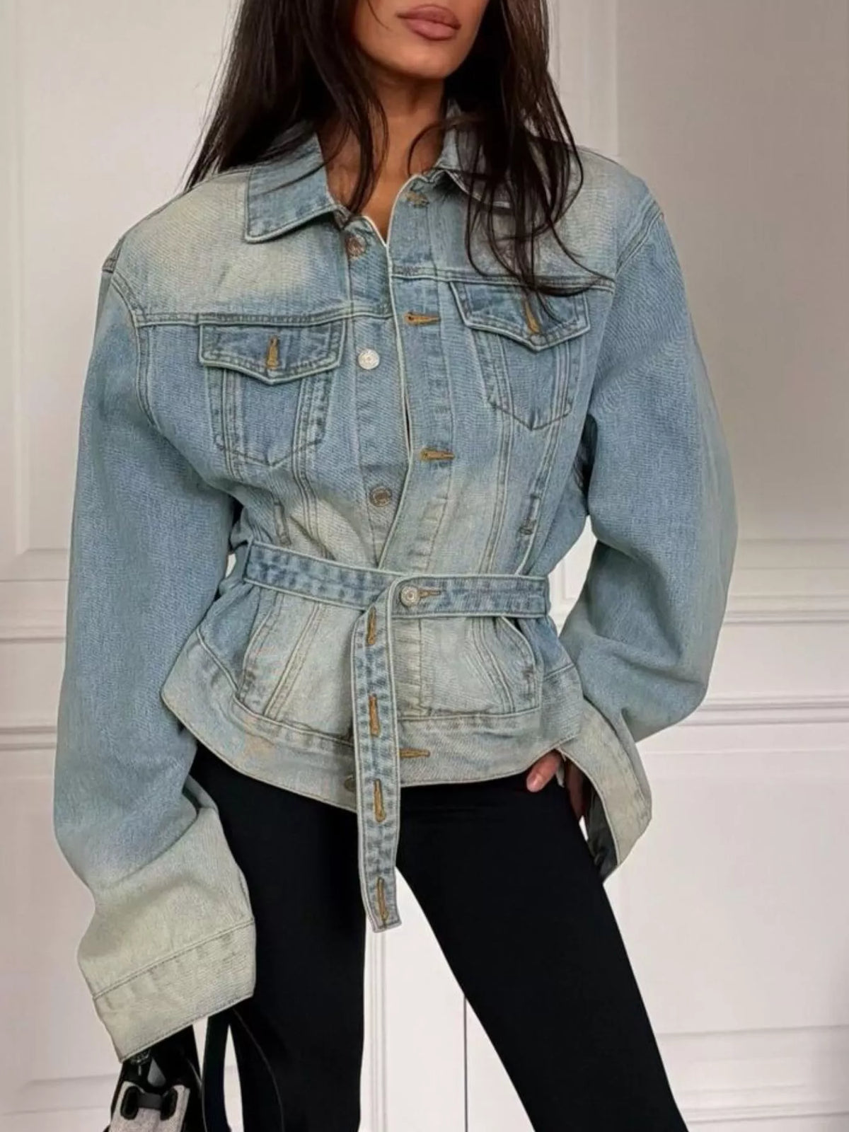 Light blue washed belted denim jacket, front view belted.