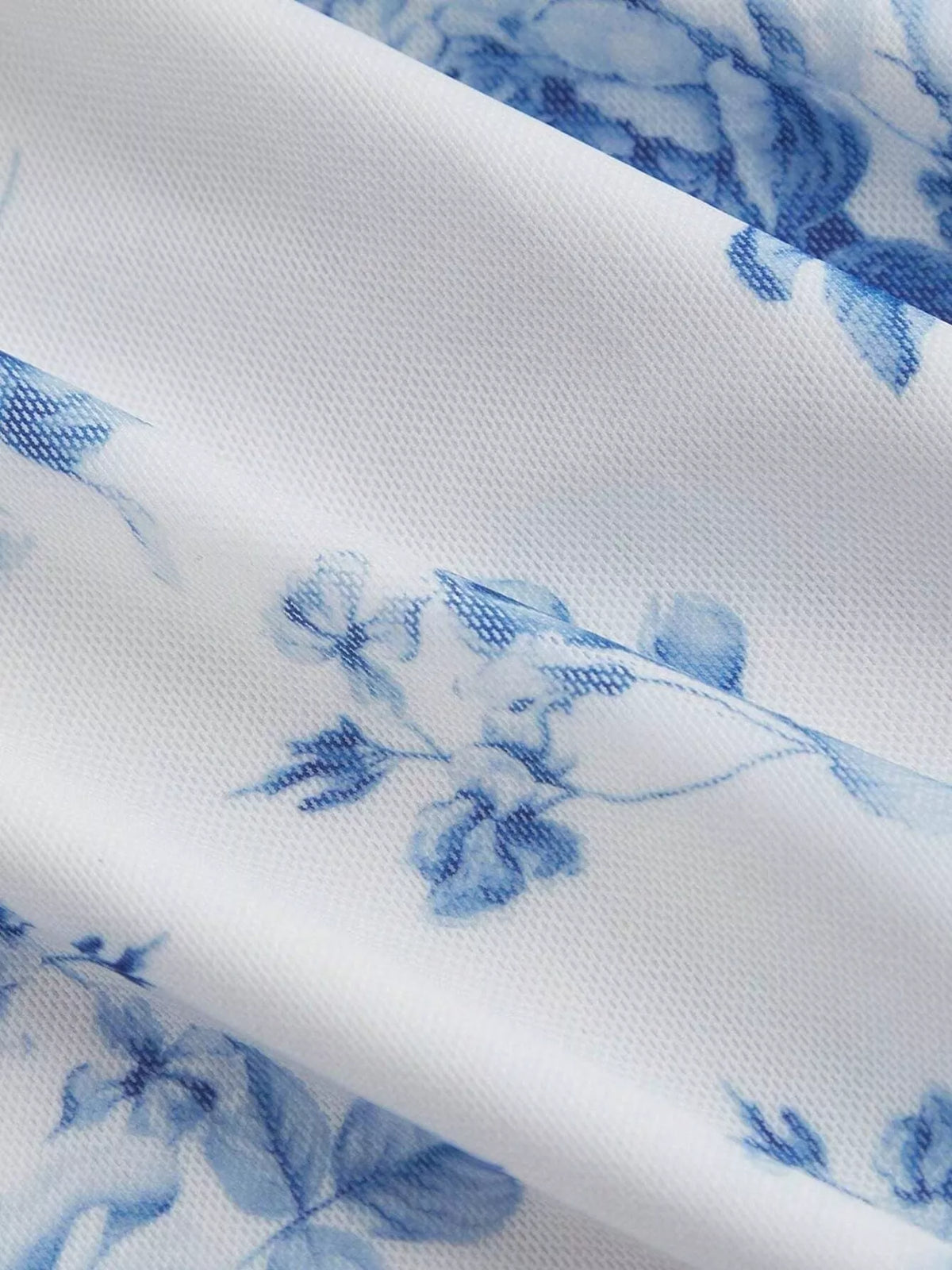 Blue and white floral bodycon midi dress, floral fabric close-up.