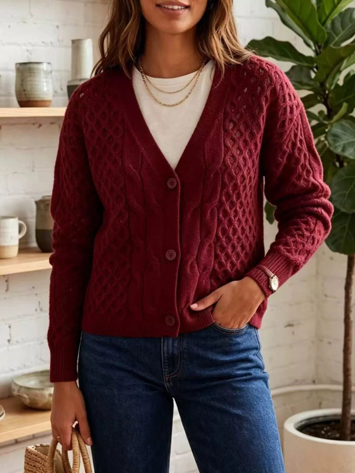 Burgundy cable-knit v-neck button-front cardigan, front view.