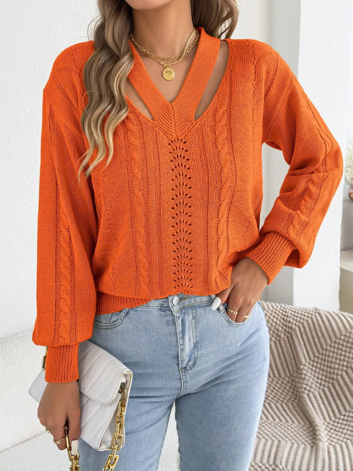 Orange cut-out cable knit sweater