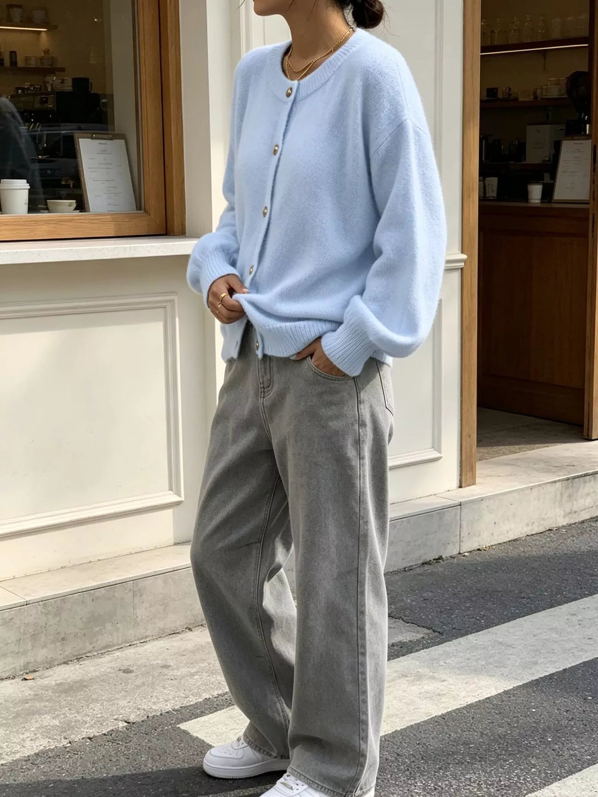 Light blue round-neck button-front knit cardigan, angled front view.