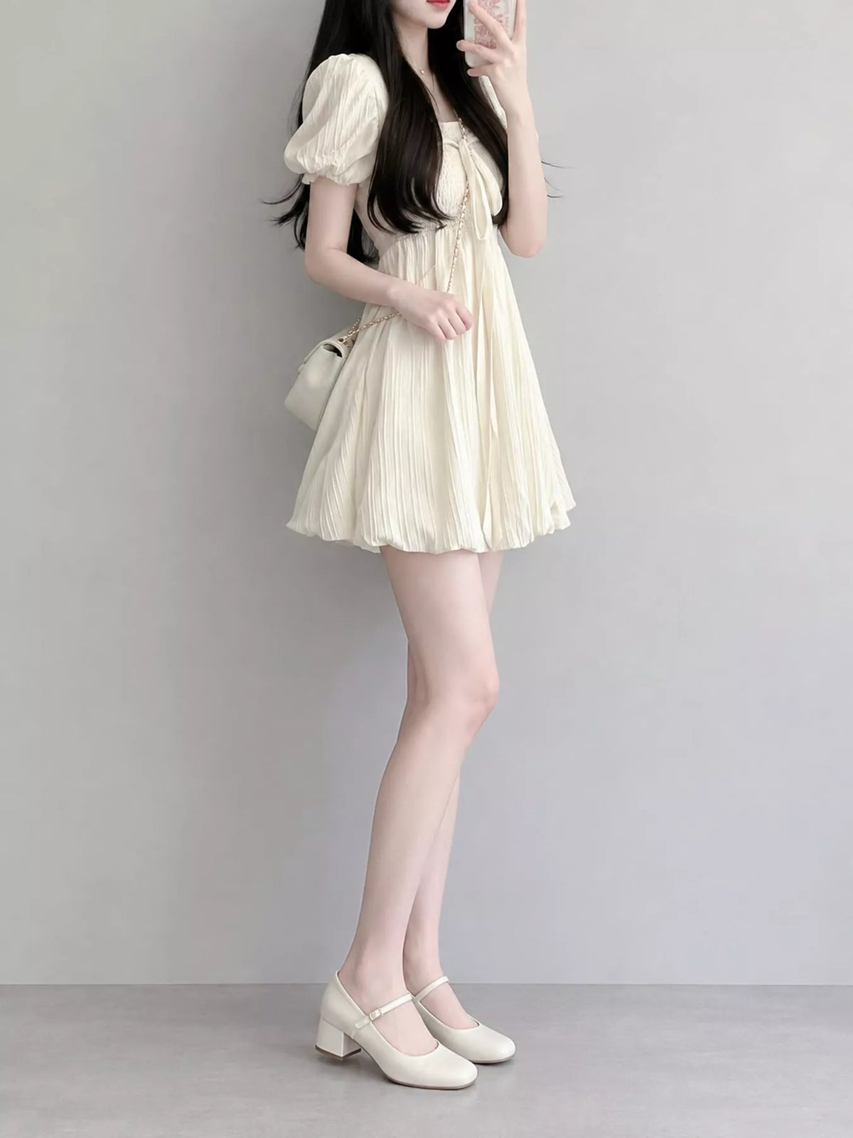 Cream puff-sleeve smocked mini dress with tie-front detail, side view