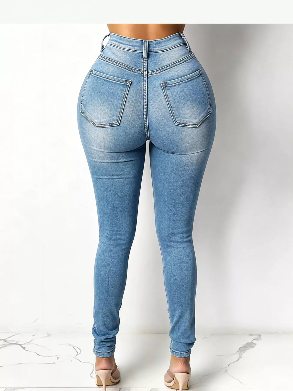 Blue high-waisted skinny jeans, back view