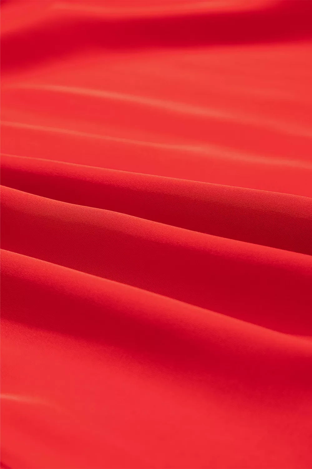 Red lace-panel v-neck button-front shirt, fabric close-up.
