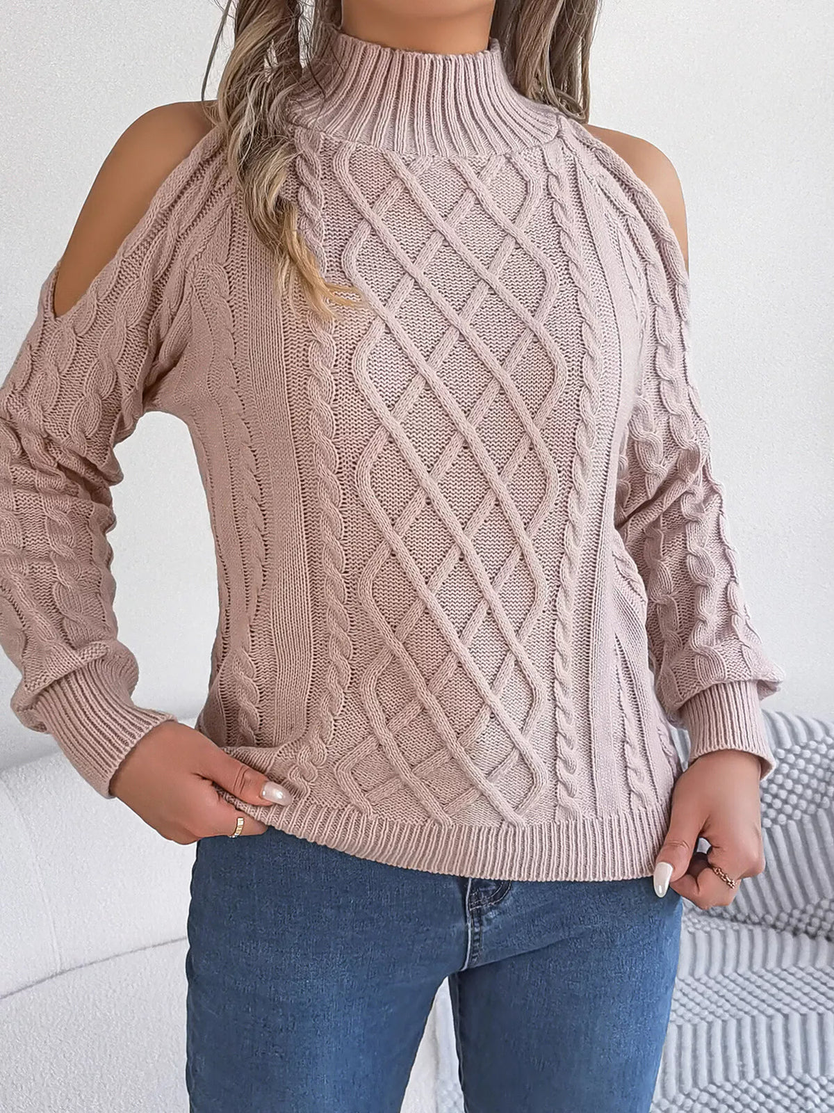 Pink cold-shoulder cable-knit sweater, untucked front view.