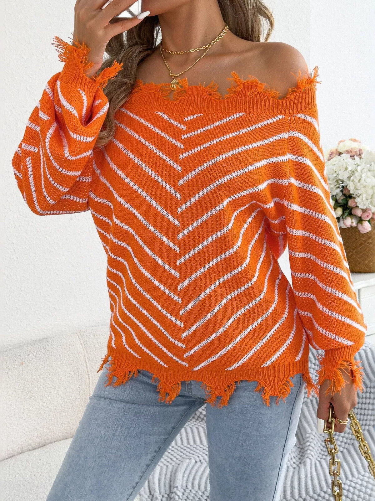 Orange off-shoulder distressed striped sweater