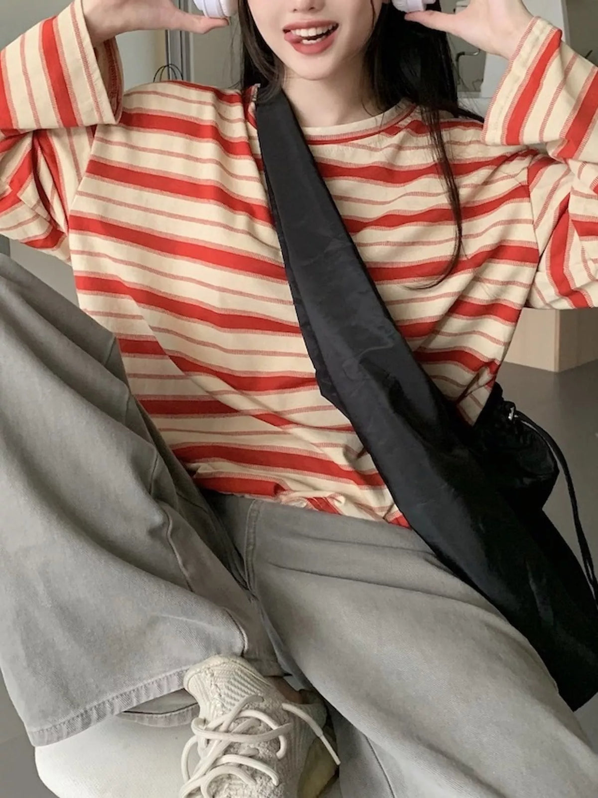 Red and cream striped oversized T-shirt, front seated view