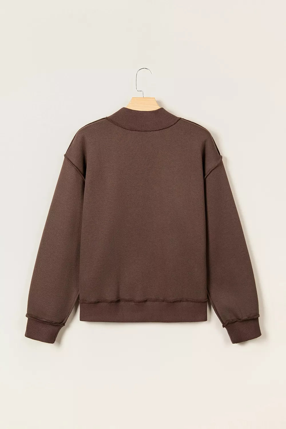 Brown wwjd patchwork graphic mock-neck sweatshirt, back on hanger.
