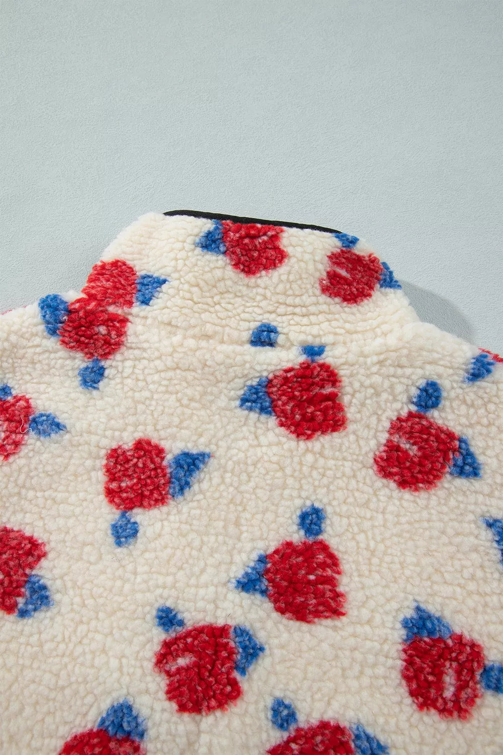 Cream with red flowers floral zip-up fleece jacket, shoulder fabric detail.