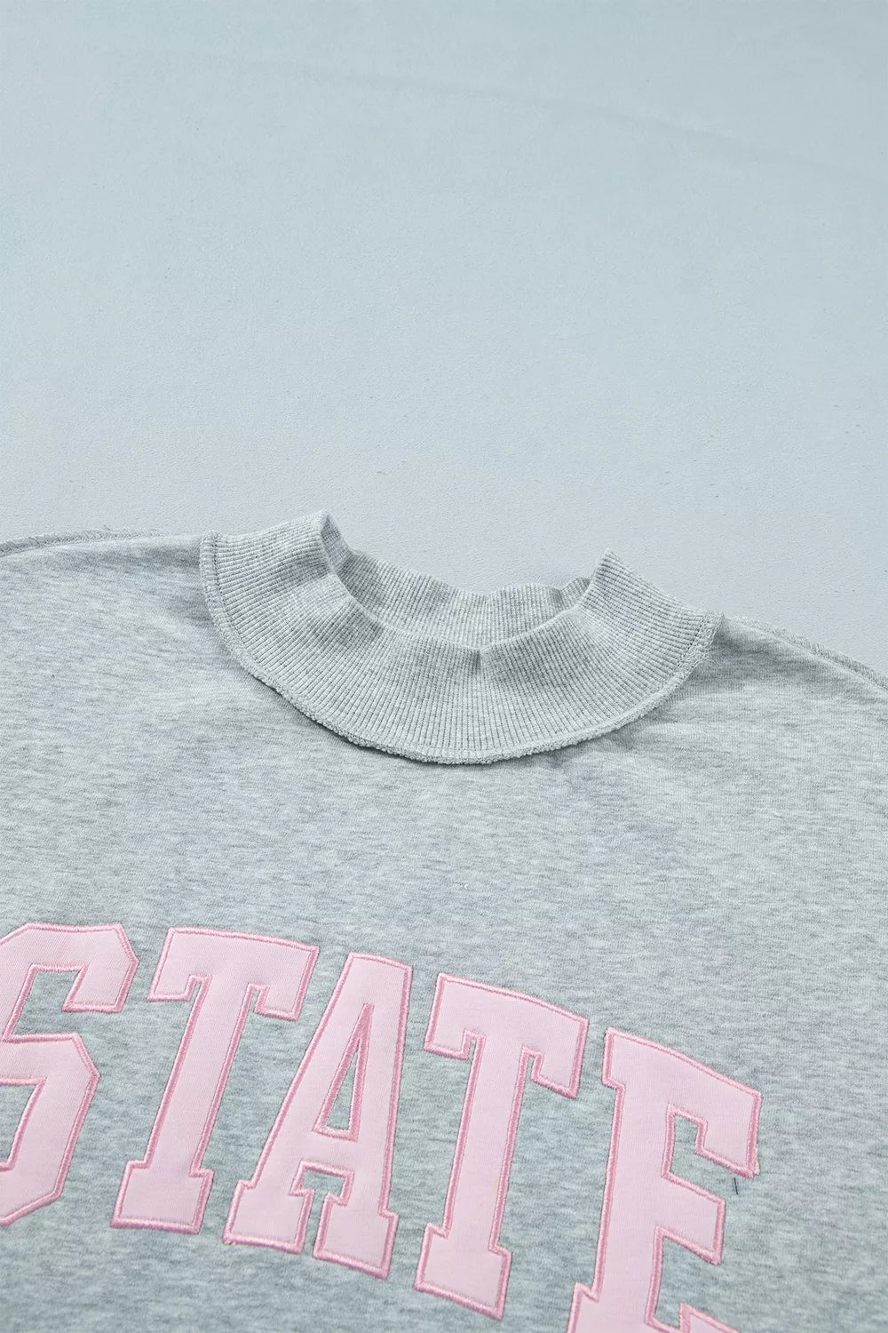 STATE Graphic Exposed Seam Mock Neck Sweatshirt in gray, lettering detail