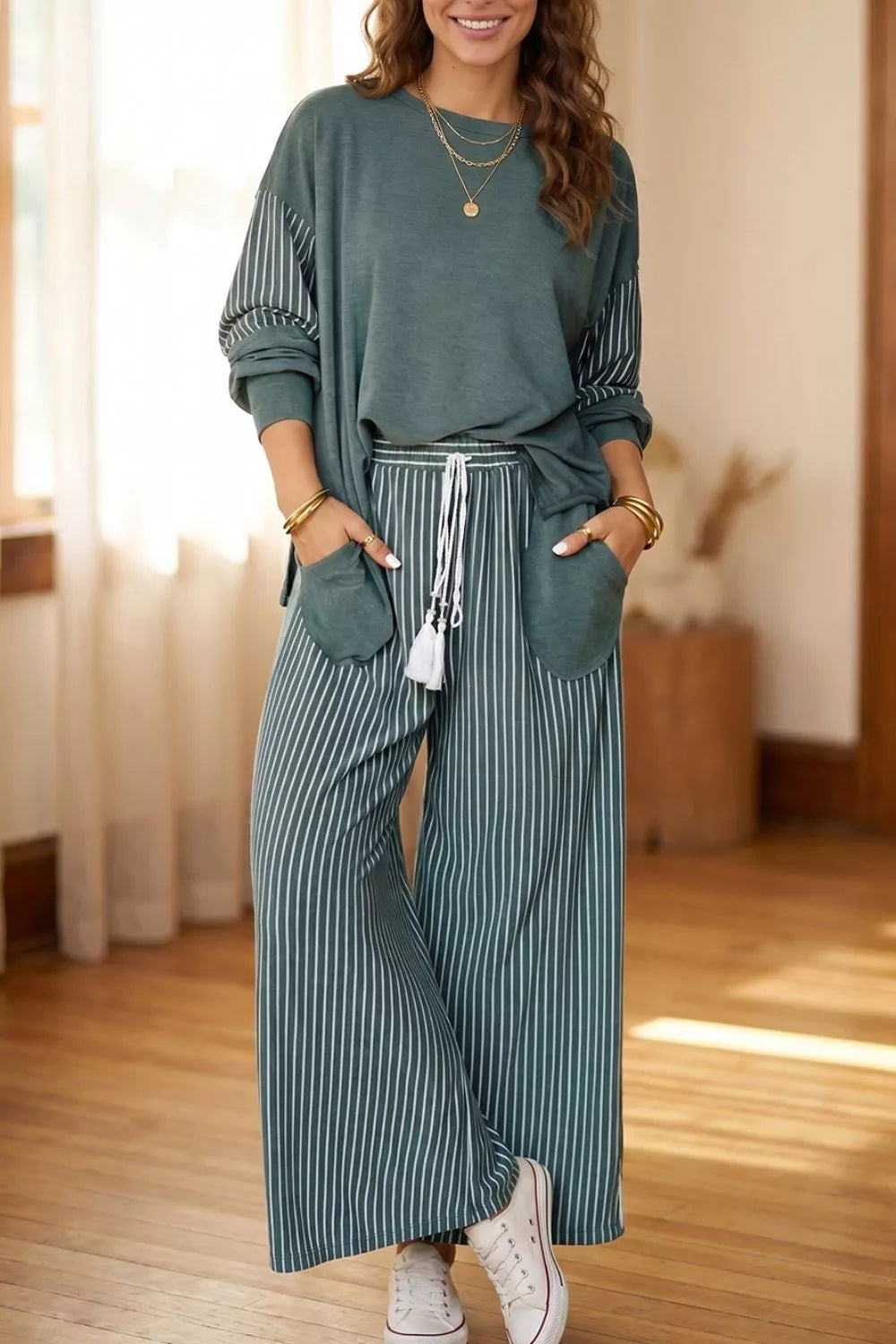 Green raw-seam top and striped pants set, front view