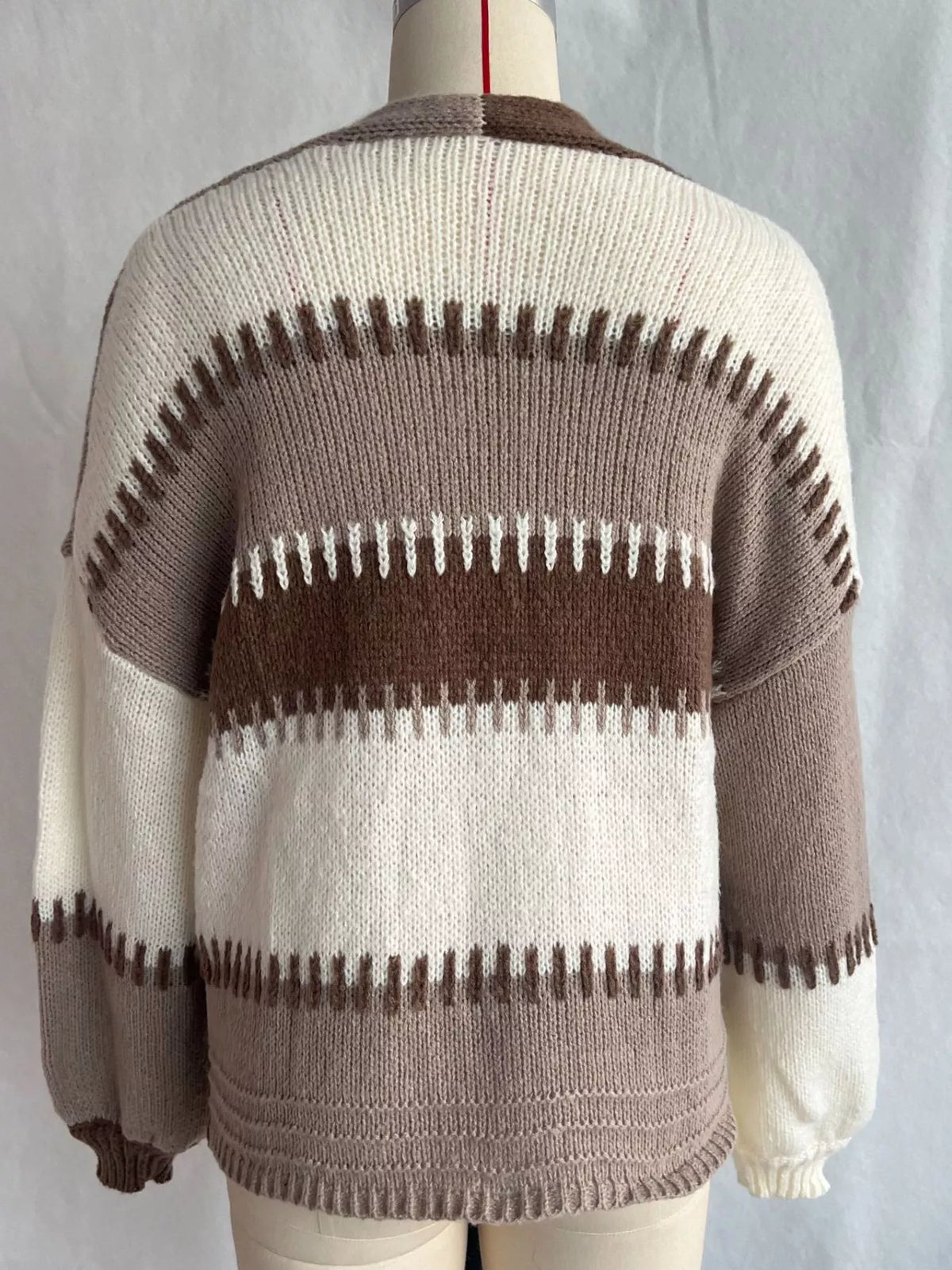 Brown color-block v-neck cardigan, back on dress form.