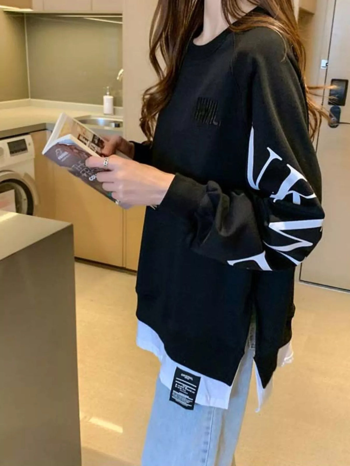 Black layered-hem sweatshirt with graphic sleeve detail