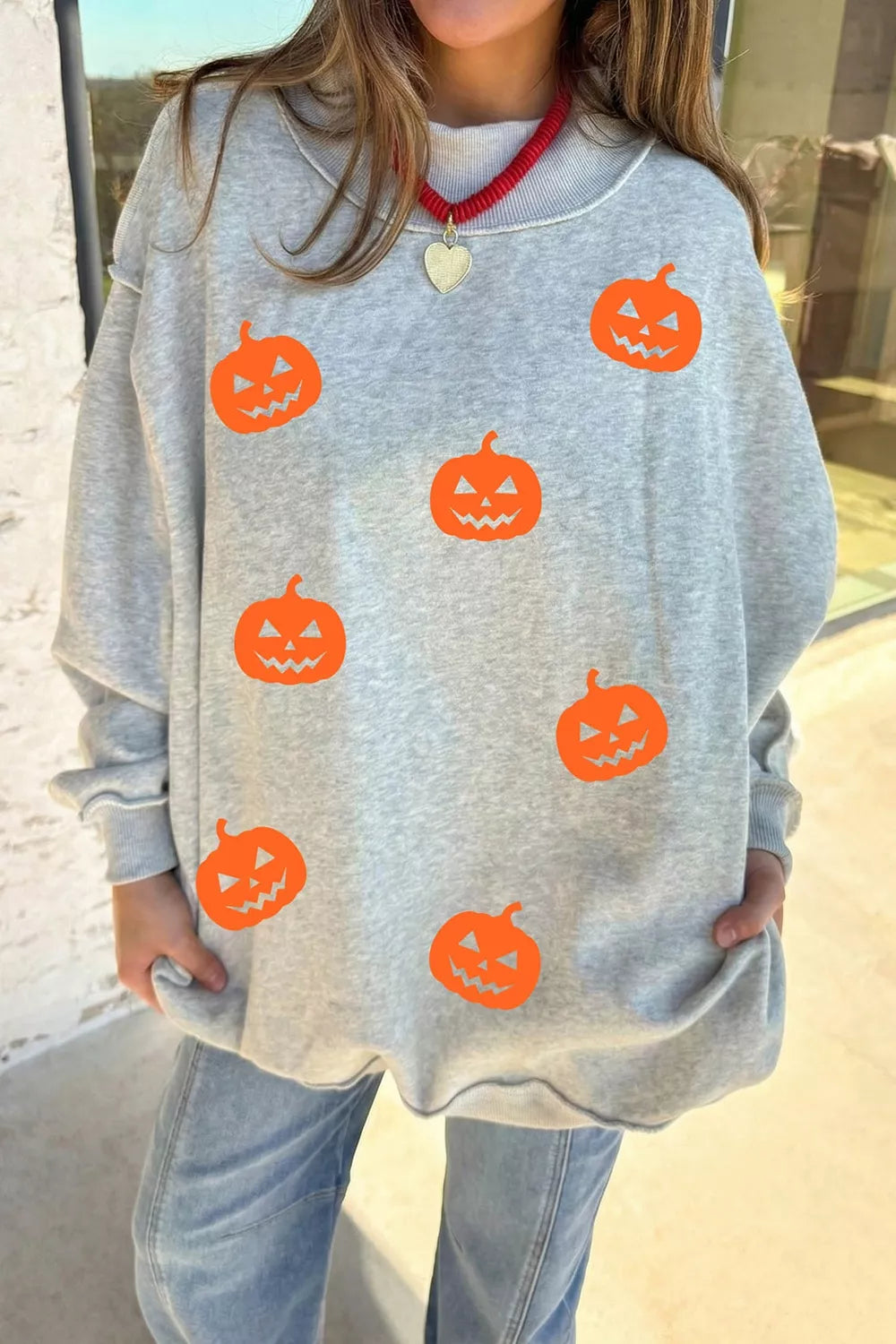 Women's pumpkin face print mock-neck reversible Halloween sweatshirt