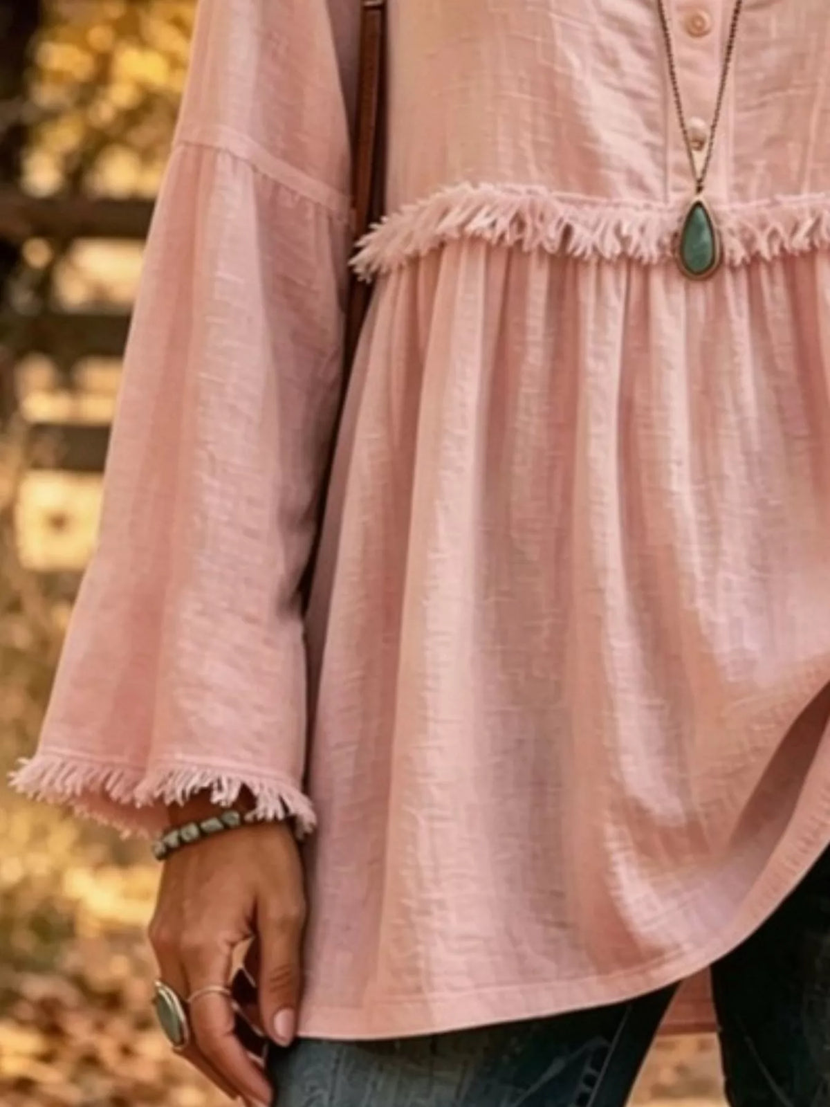 Pink fringed button detail blouse, frayed sleeve edge, waist seam, and flared hem