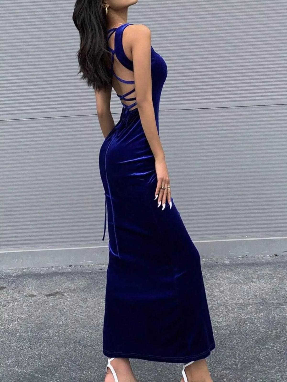 Royal blue velvet lace-up back bodycon maxi dress, angled back view.