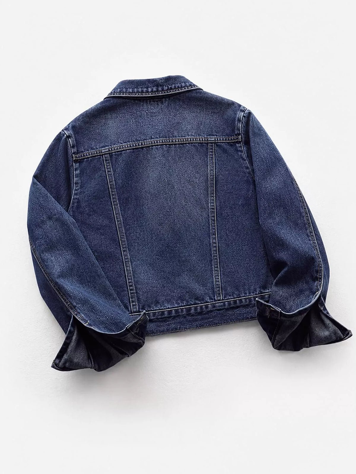 Medium blue button-down front denim jacket, back view
