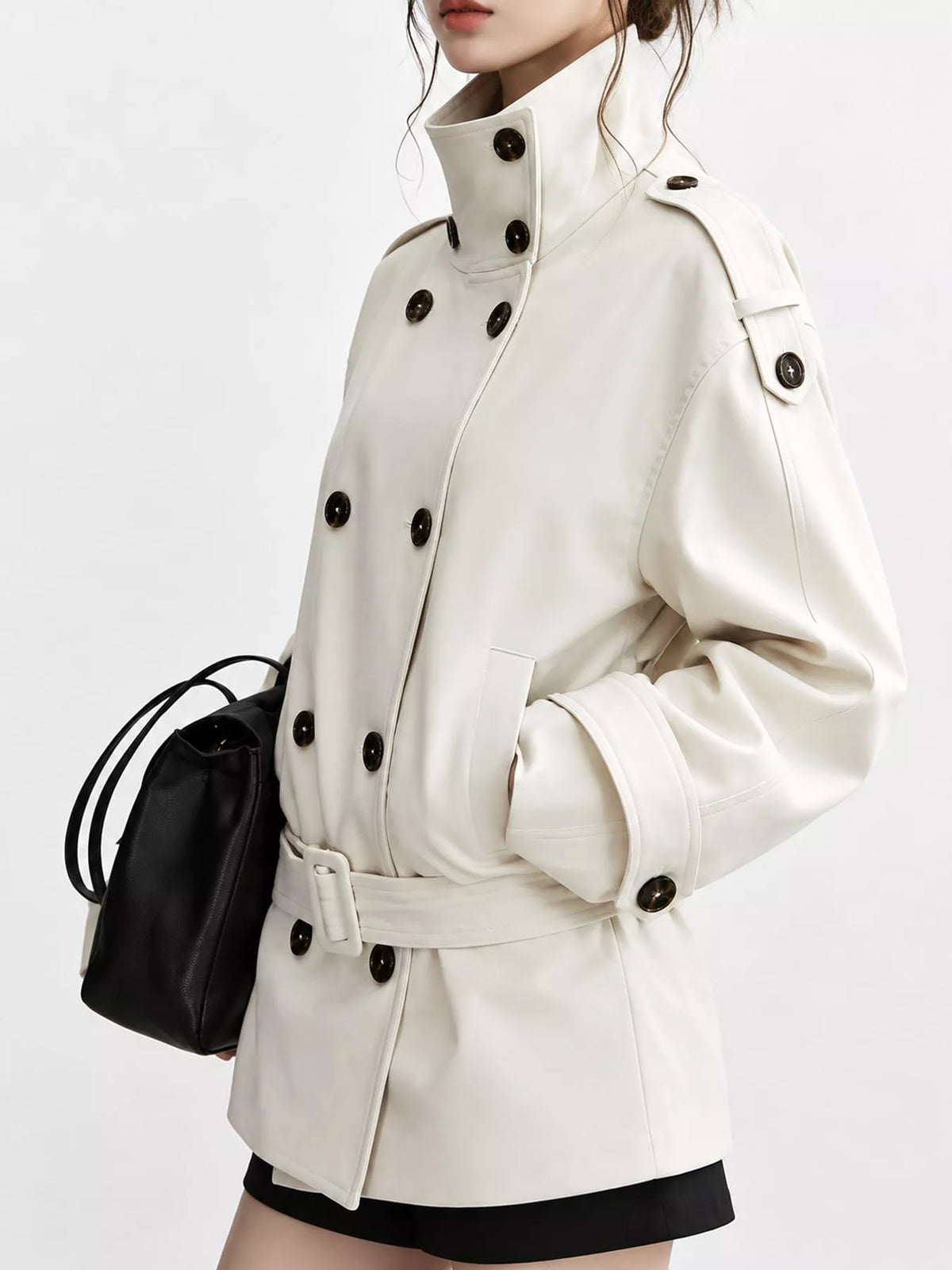 Cream double-breasted high-neck belted trench coat, side view