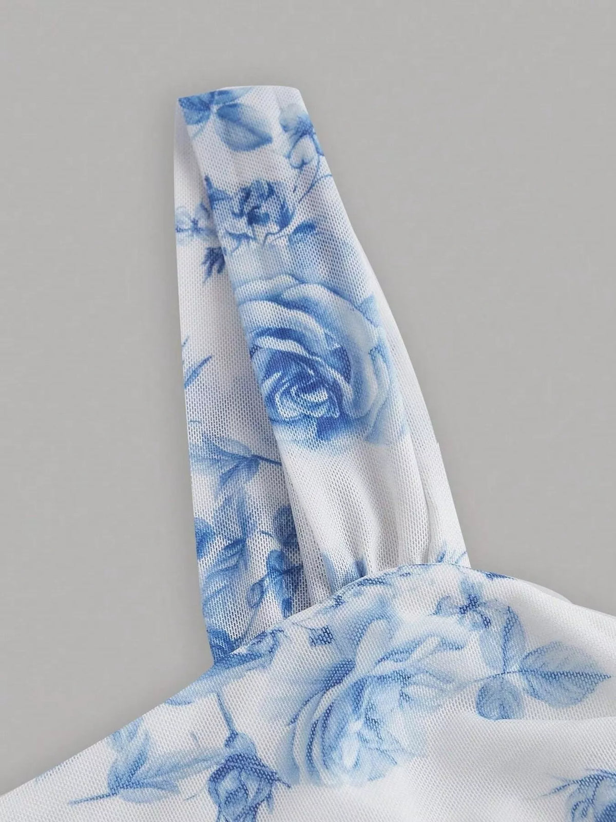 Blue and white floral bodycon midi dress, shoulder strap detail.