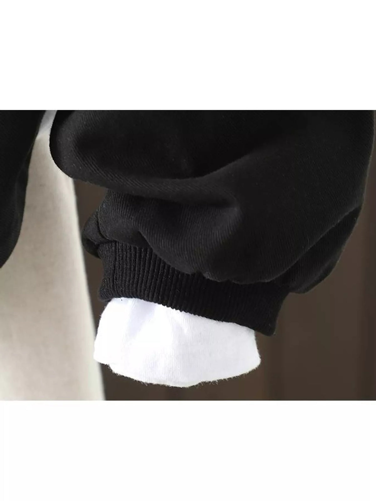 Black snap front dropped shoulder jacket, detail view