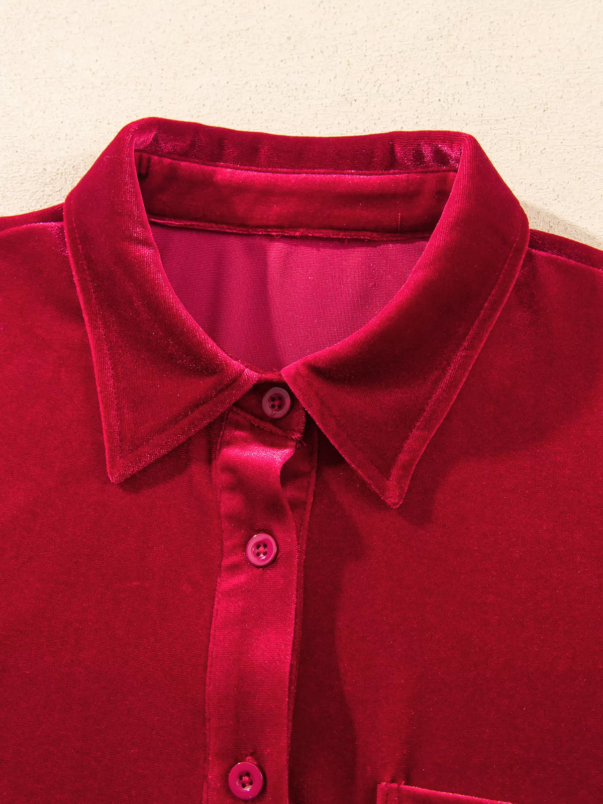 Collar and button placket on red velvet button-down shirt with patch pockets