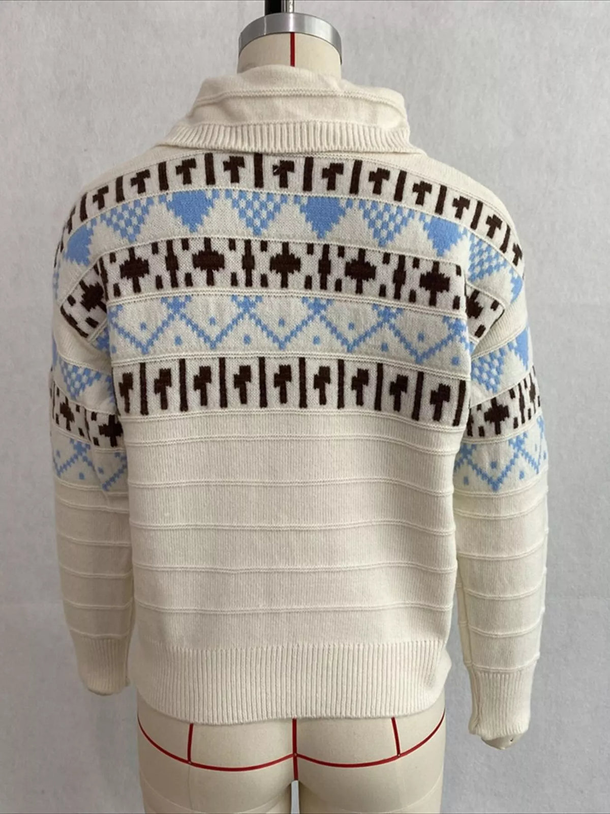 Cream fair isle polo-collar sweater, back on dress form.