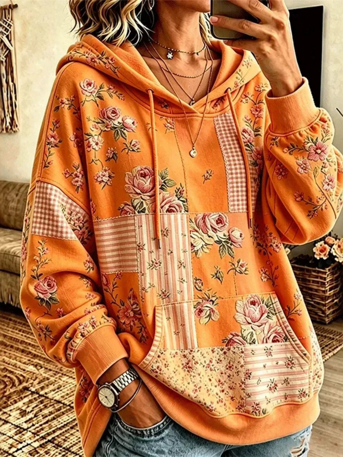 Orange floral drawstring dropped-shoulder hoodie, front view.