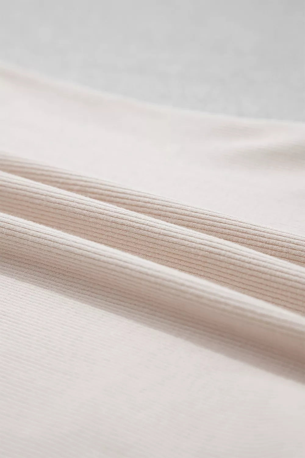 Beige lace-cuff long sleeve top, fabric close-up