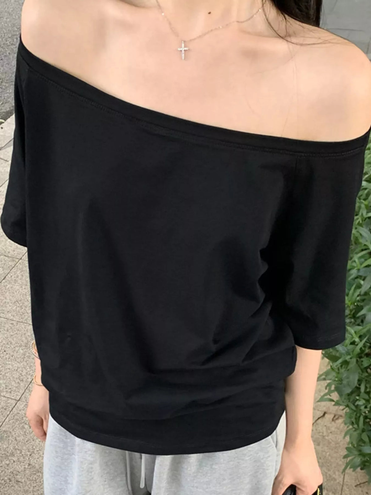 Black asymmetric-neck T-shirt, neckline detail