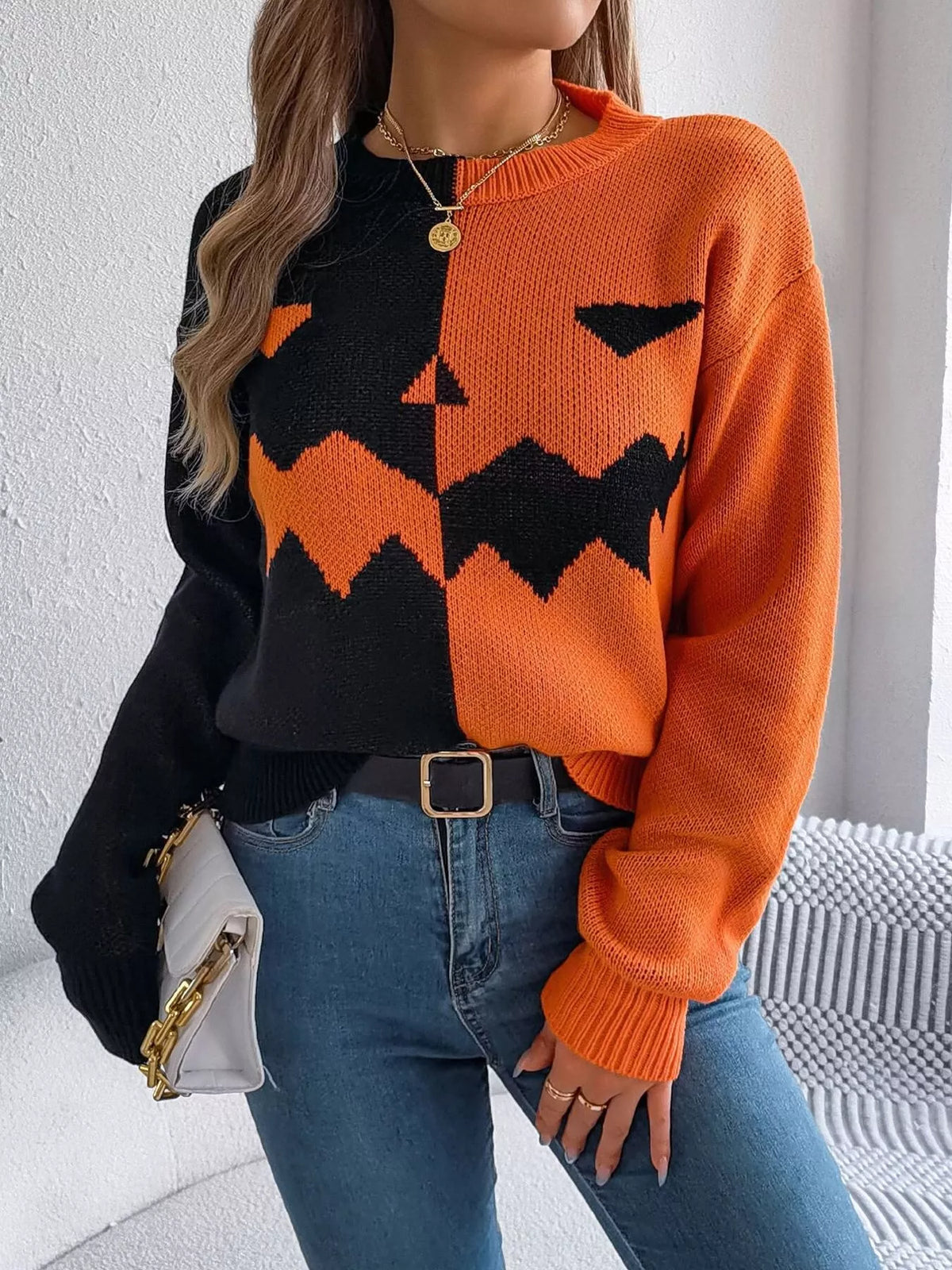 Pumpkin Face Graphic Two Tone Sweater in orange and black, front view