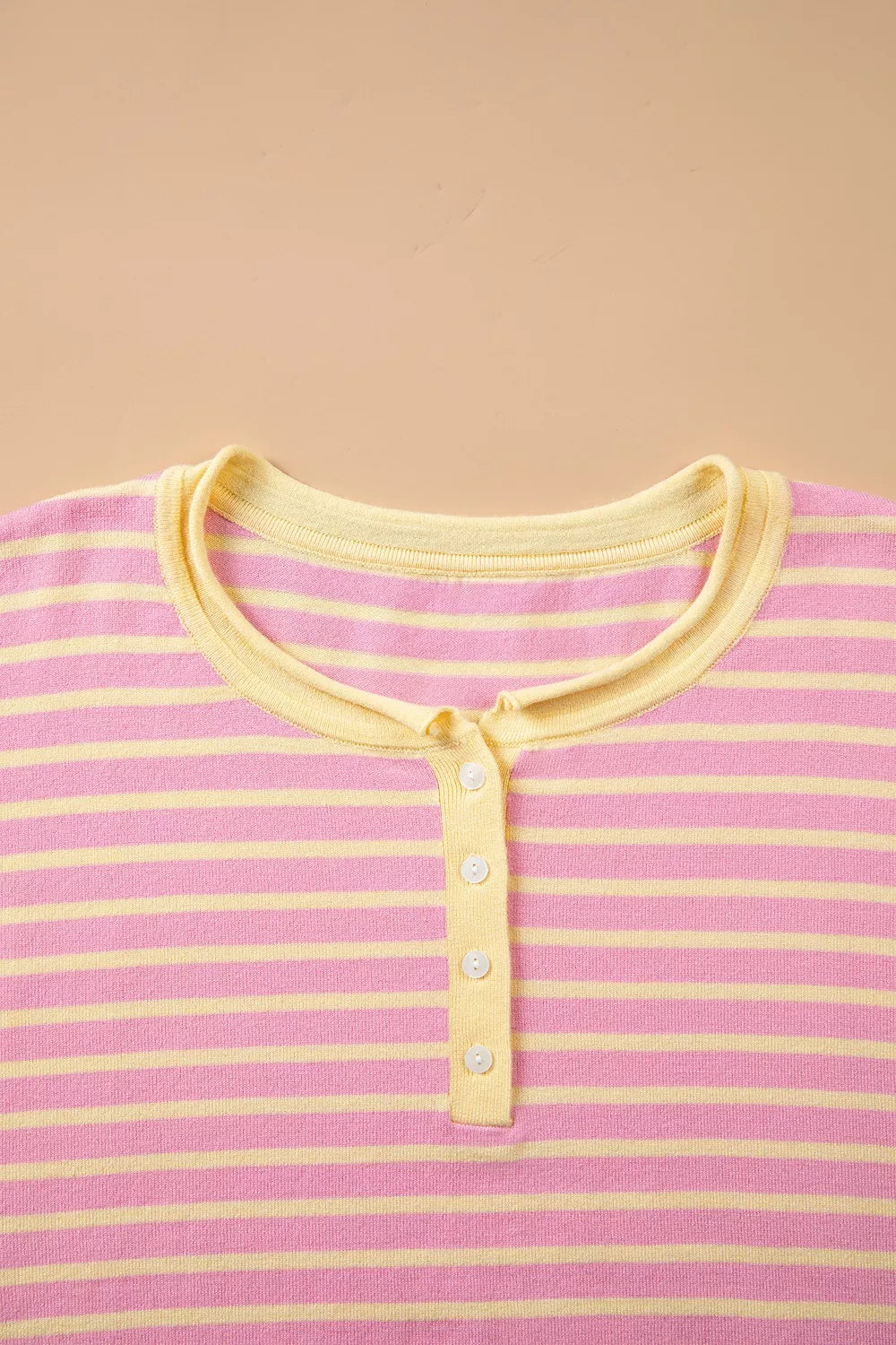 Pink and yellow striped button-detail sweater, neckline detail