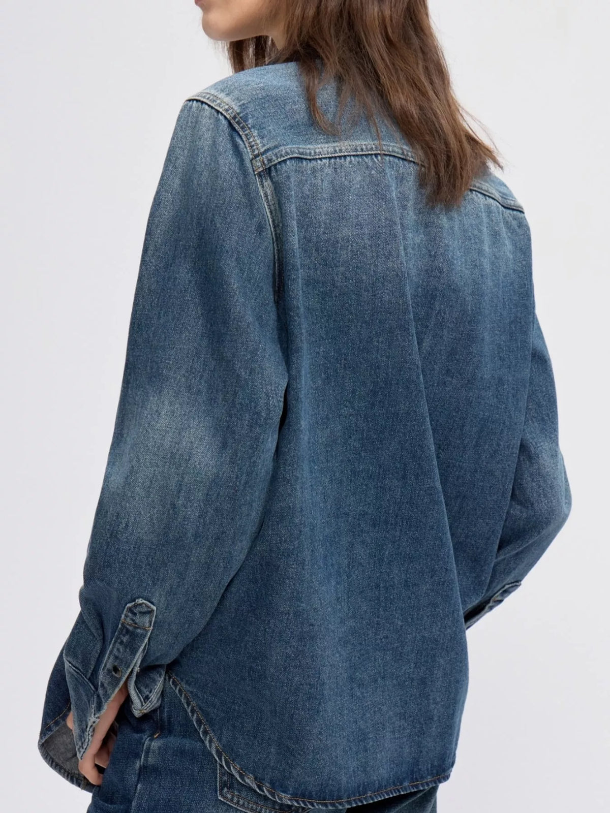 Blue snap down long-sleeve denim shirt, back view